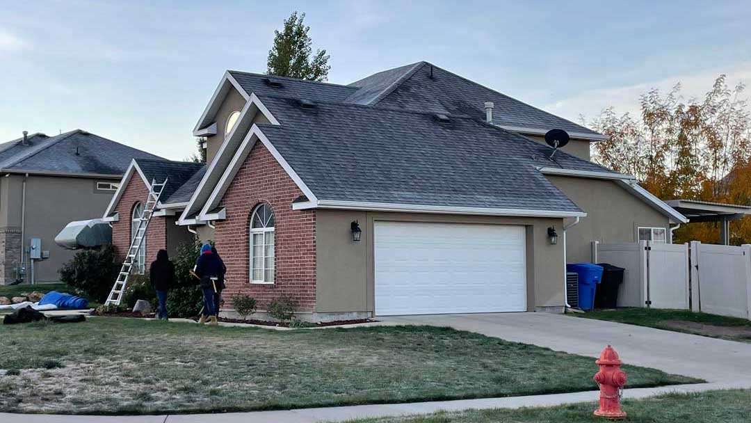 Roofing crew preparing for a roof replacement on a home in Lindon, Utah during a crisp fall morning.