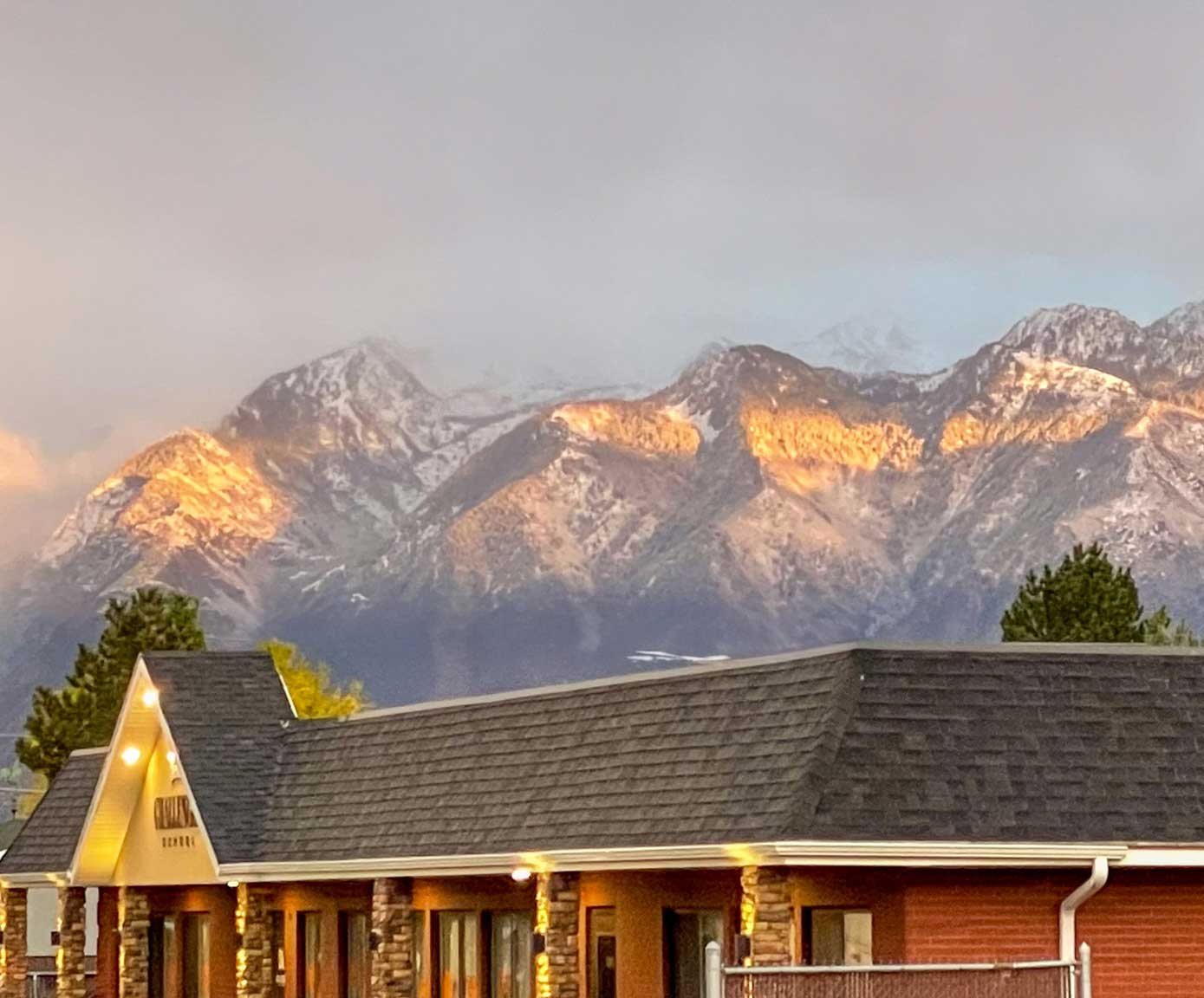 Shingle roof installation on a Utah home with snowy mountain backdrop