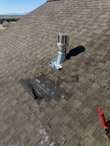 Damaged roof with missing shingles and visible water stains in Utah home