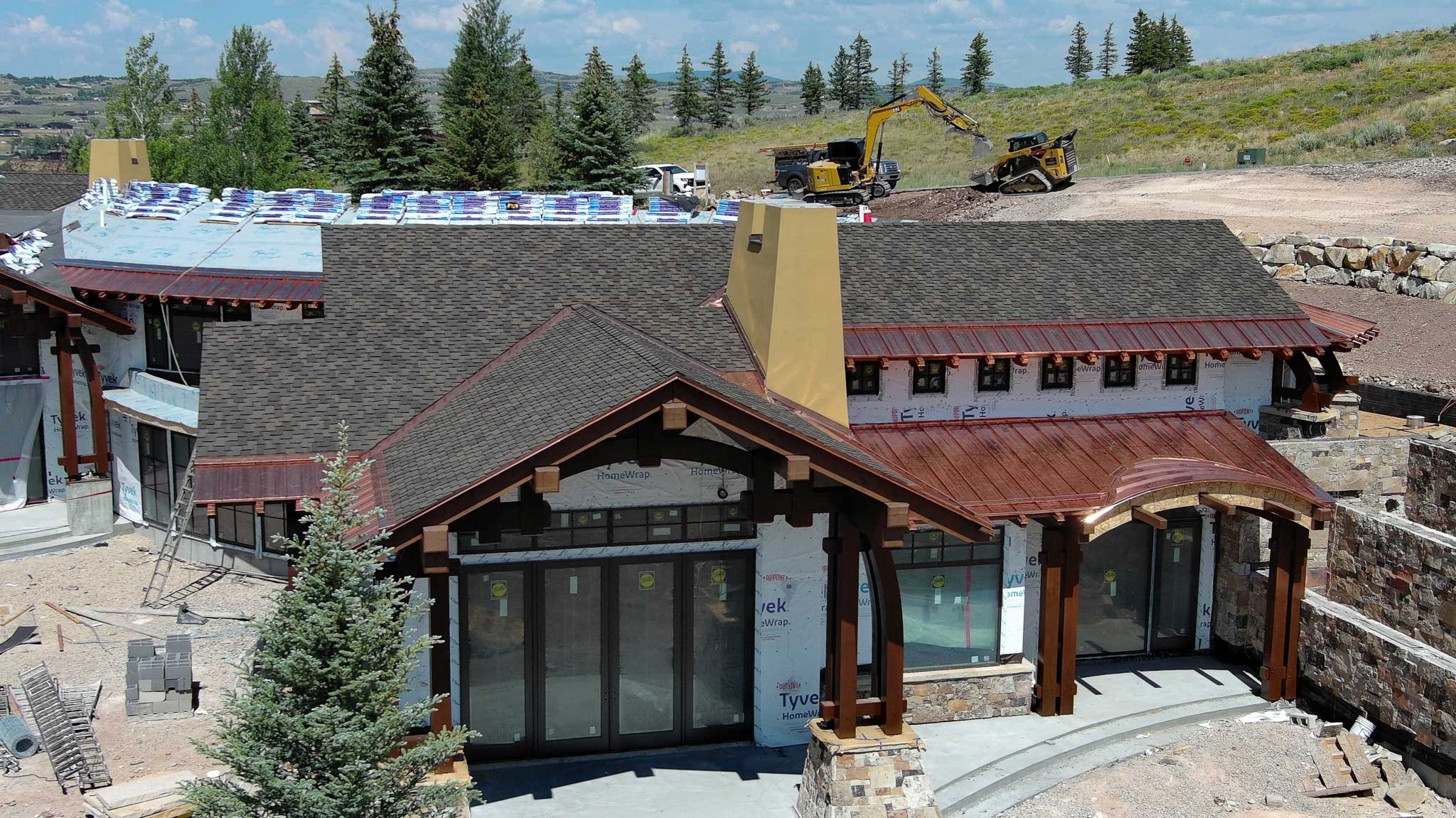 Metal roofing installation in Park City with stunning mountain views in the background.