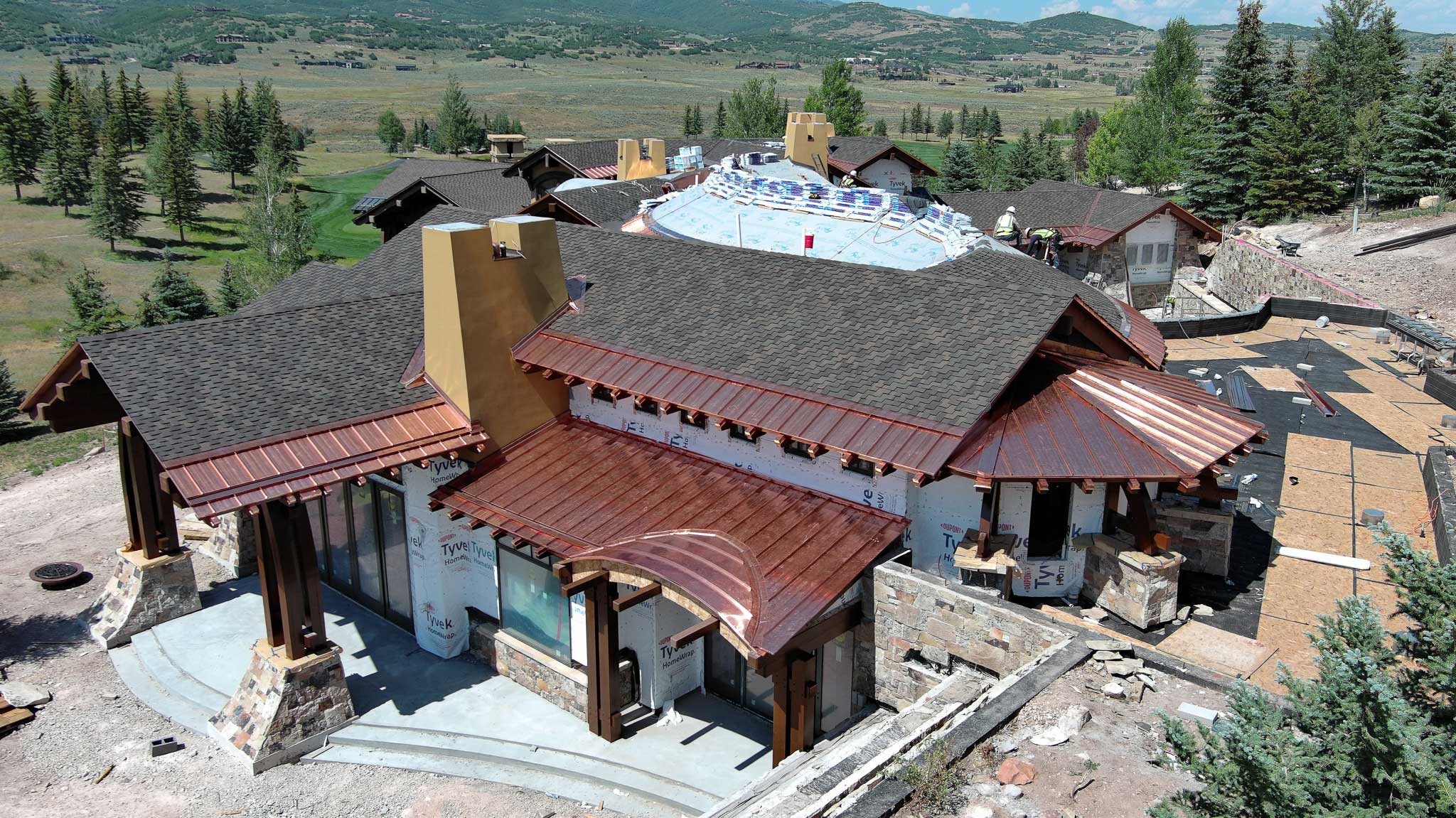 Metal roofing installation in Park City with stunning mountain views in the background.