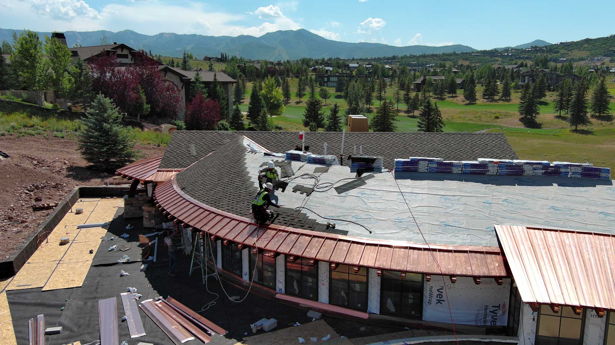 Metal roofing installation in Park City with stunning mountain views in the background.